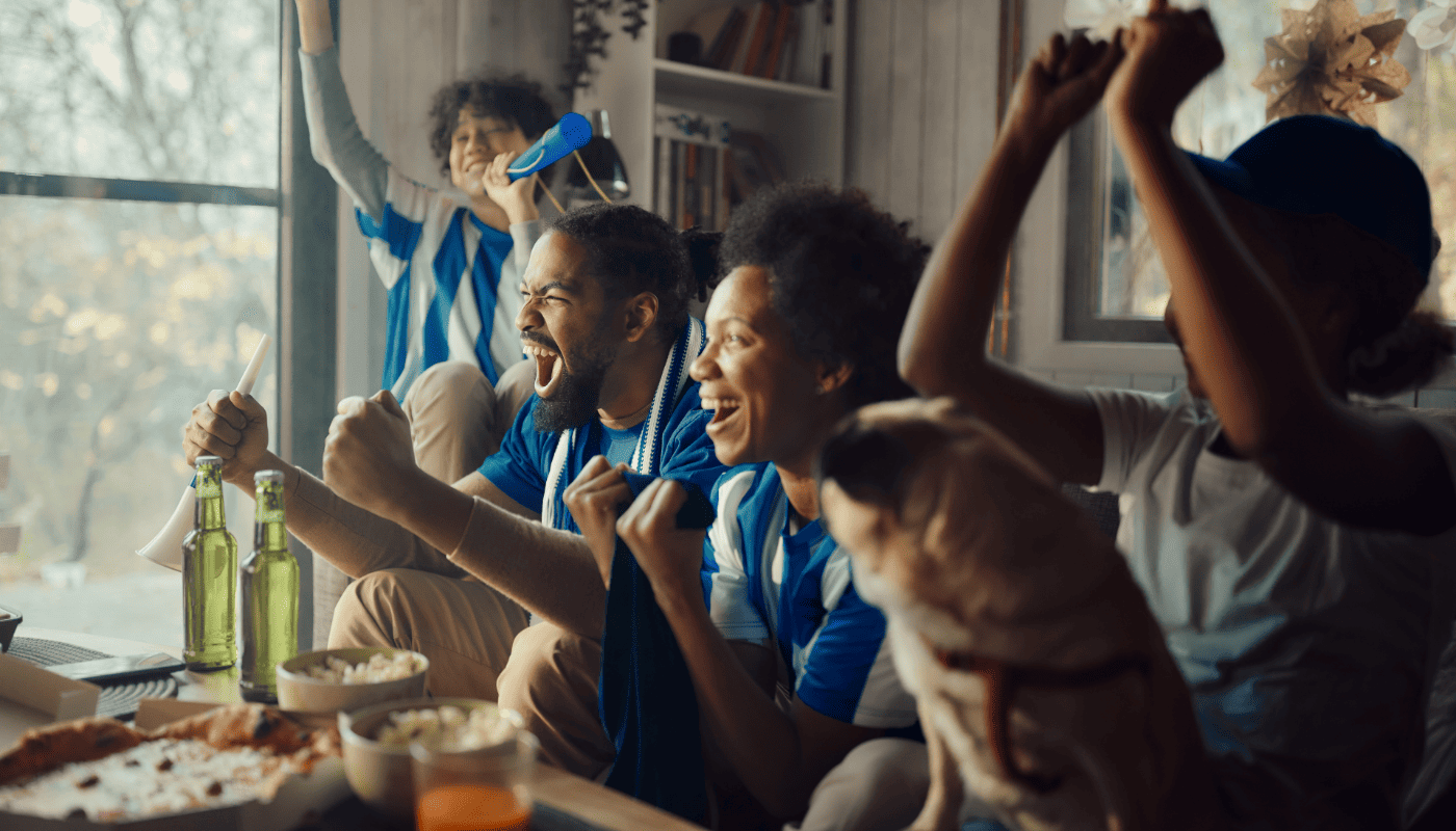 Sports fans cheering game on TV