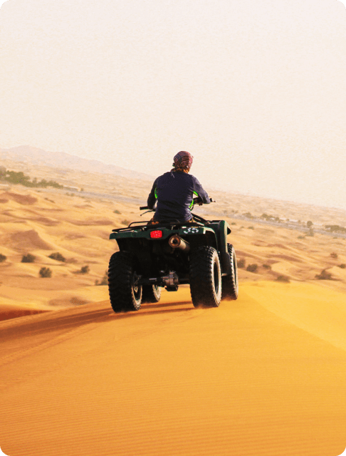 Image Description: A traveler exploring the Arabian desert on an ATV
