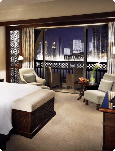 Image Description: Interior of a spacious hotel room with a private terrace facing the Dubai Fountain at the Palace Downtown
